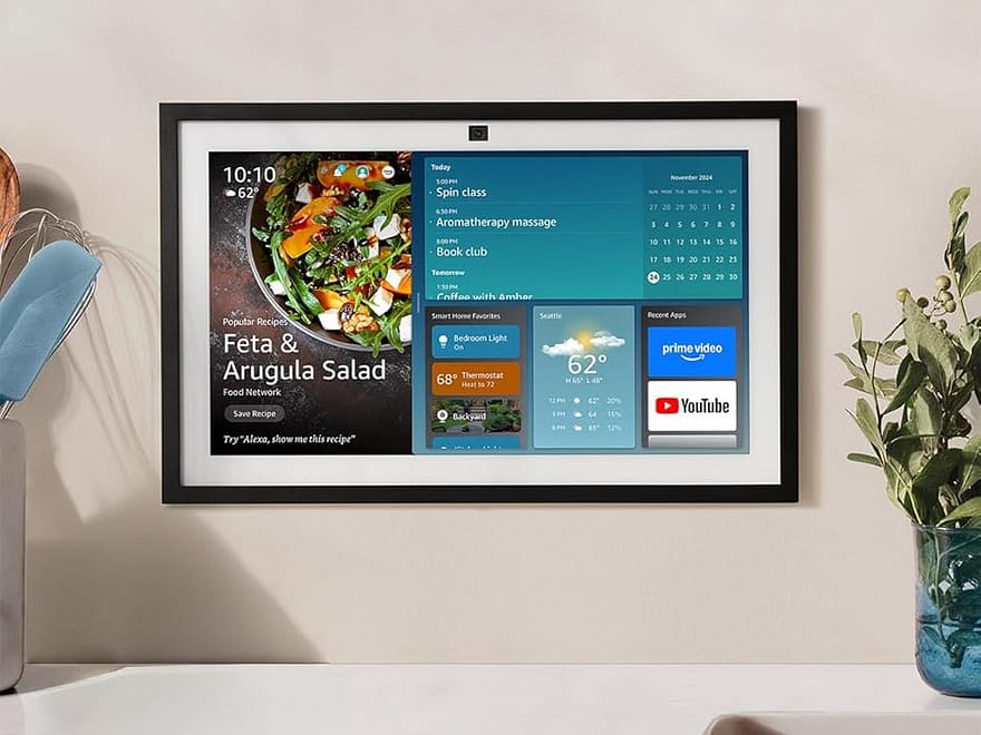 Amazon Echo Show 15 wall-mounted smart kitchen TV with black frame, home organization dashboard, above a countertop and sink