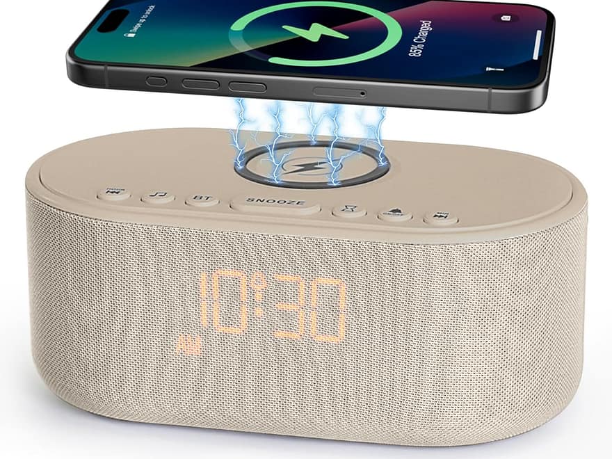 Sound machine alarm clock with beige fabric speaker, rounded shape, top controls, LED time display, and wireless phone charging